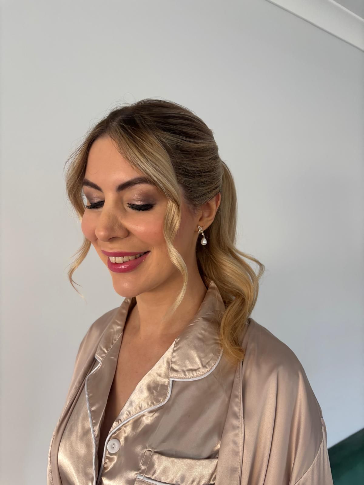 Soft bridal updo with face-framing pieces