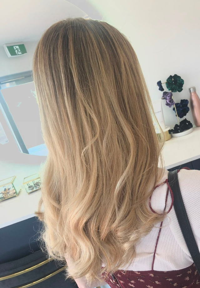 Honey blonde balayage with long soft waves