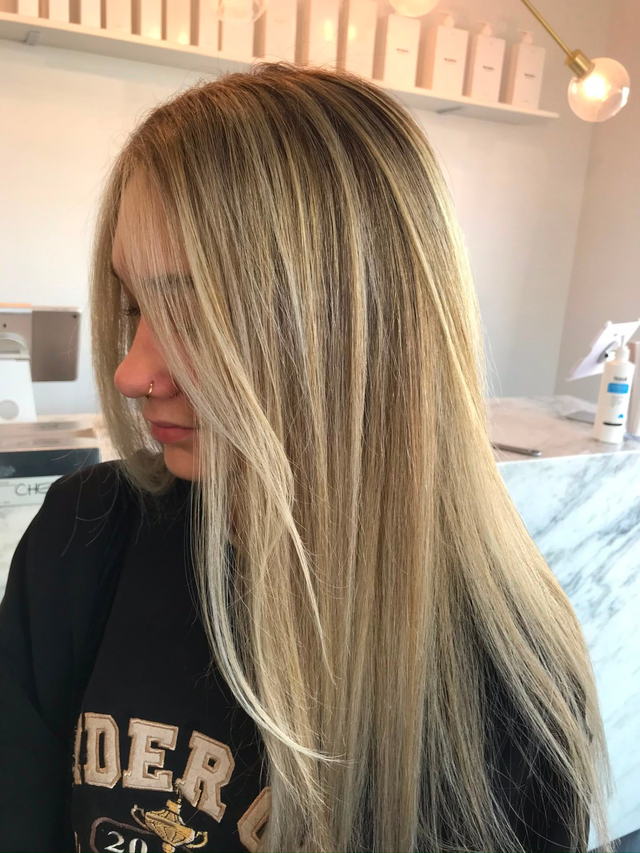 Bright blonde foils with a sleek straight finish