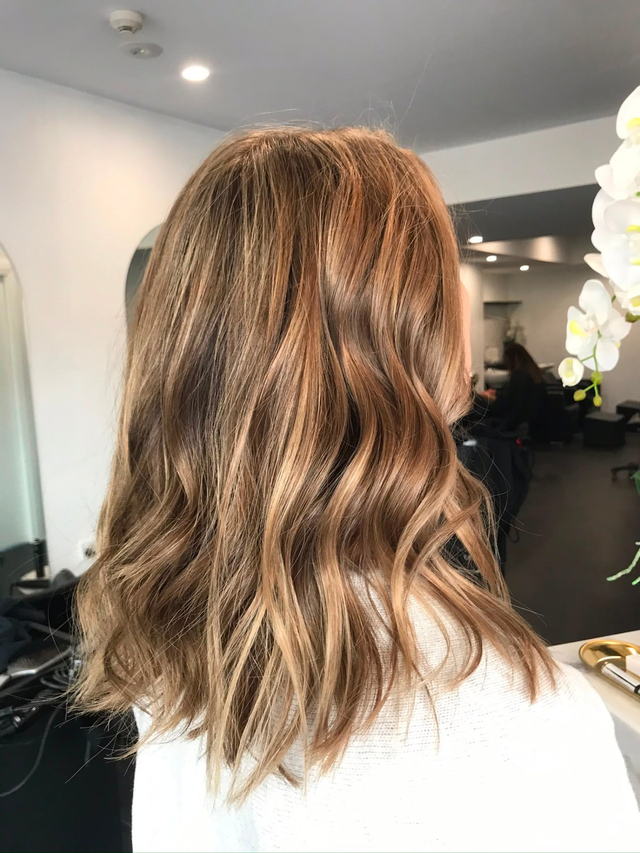 Cool blonde highlights with a sleek mid-length finish