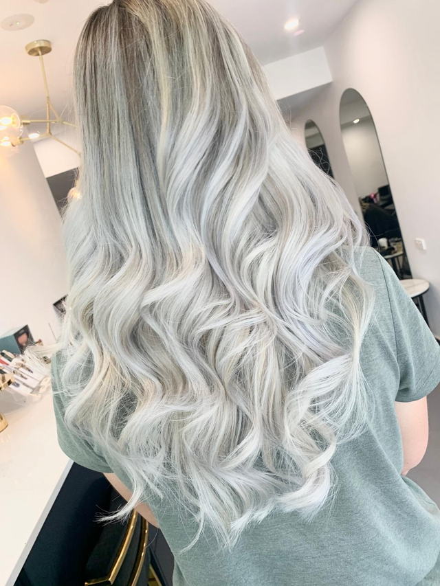 Icy silver blonde balayage with long loose waves