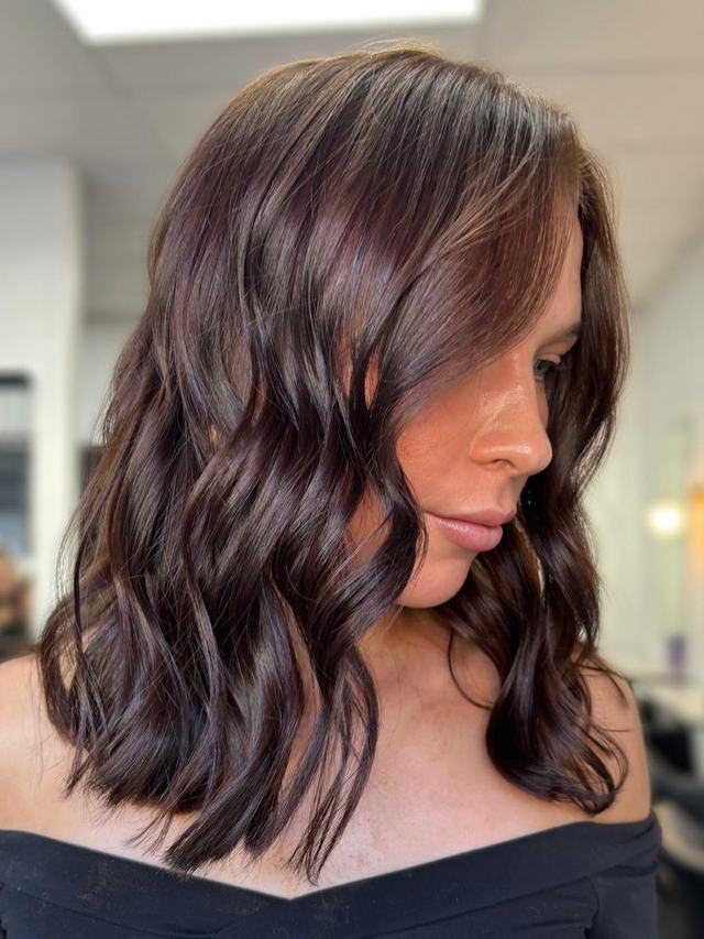 Glossy chocolate cherry brunette with soft waves