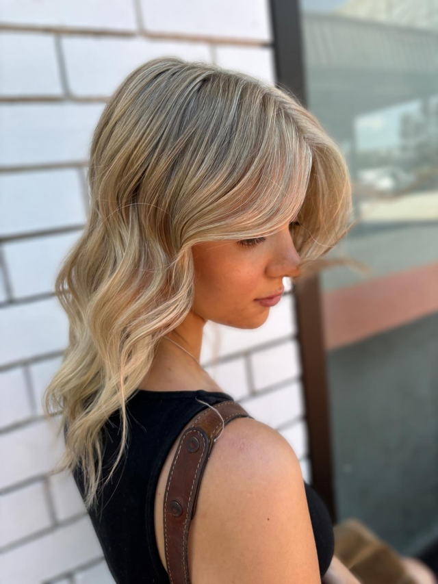 Blonde shag with curtain bangs and soft waves