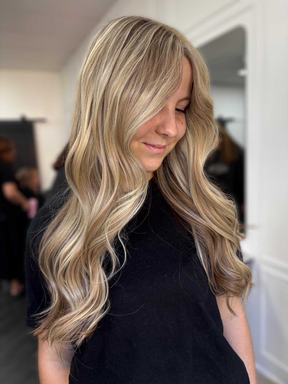 Creamy blonde balayage with long bouncy waves